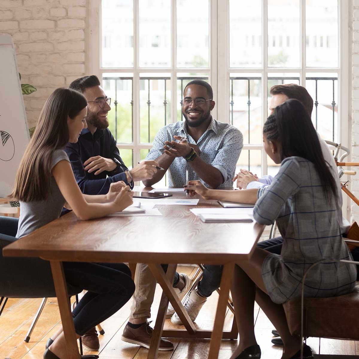 Colleagues talking around a table
